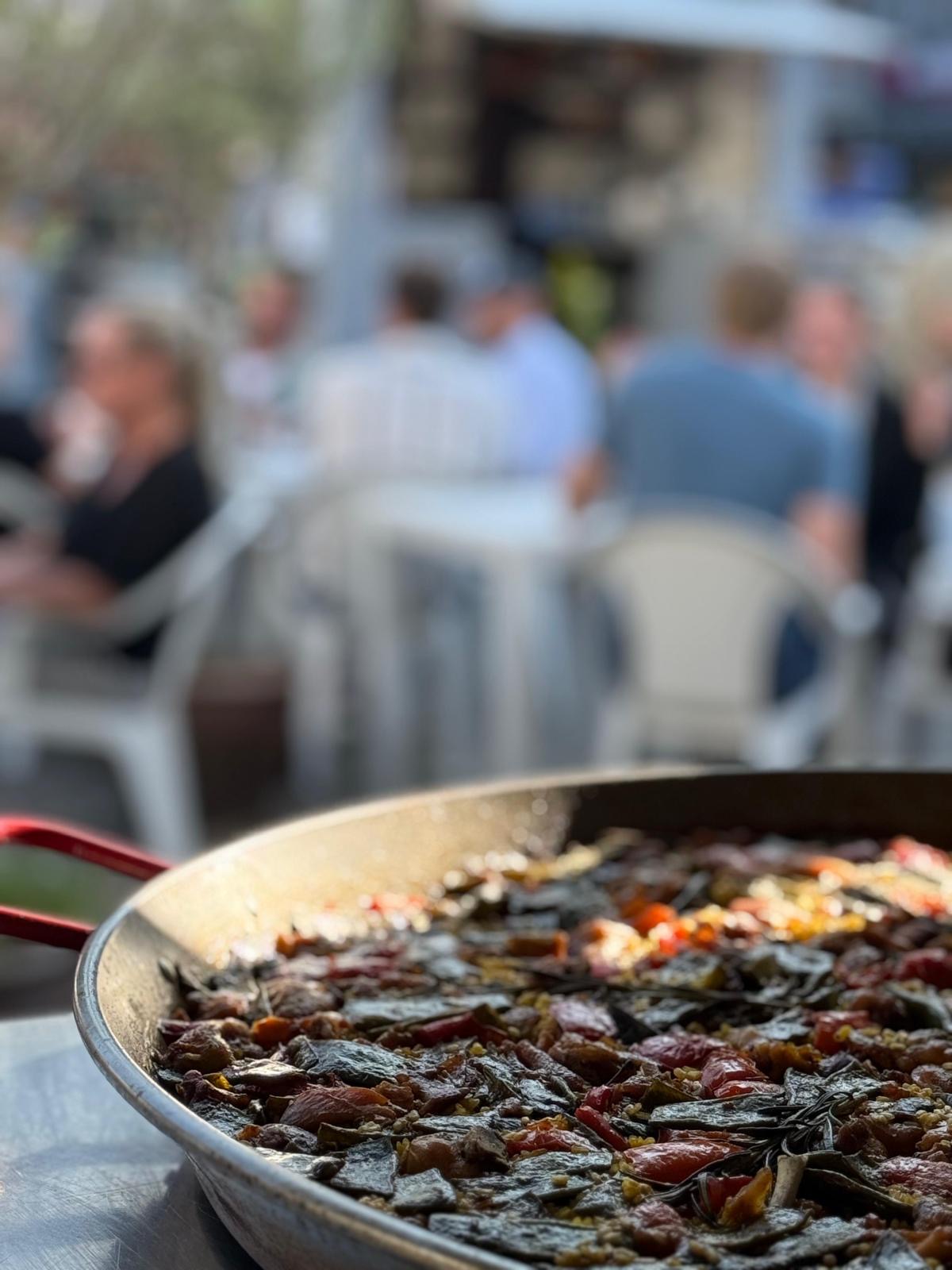 Steaming paella served fresh to guests